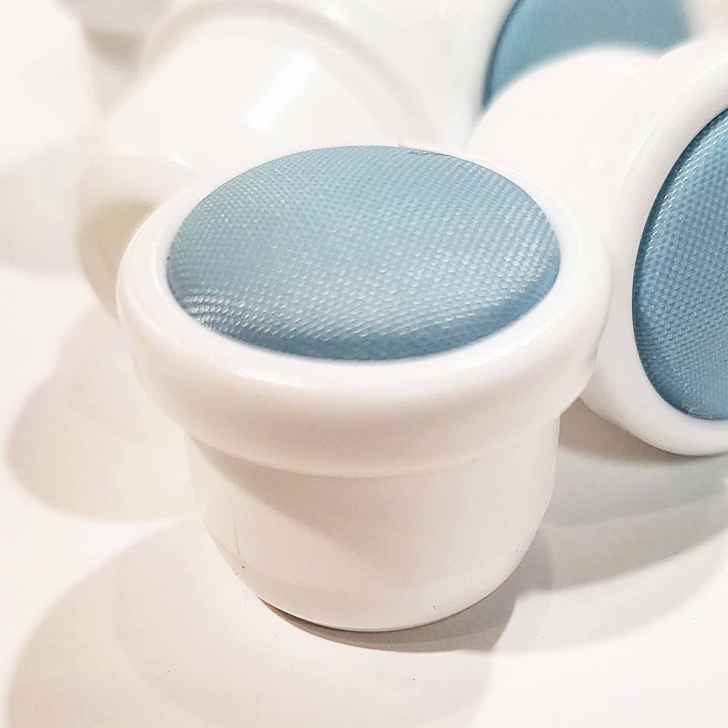 White plastic base with a blue mesh top.