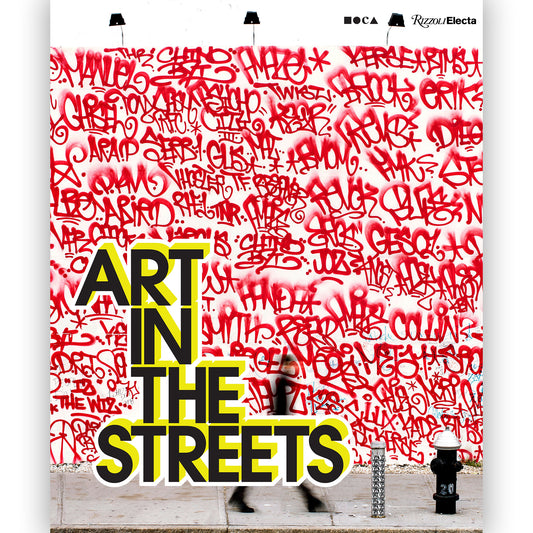 A white book with Art In The Streets written with red spray paint tags.