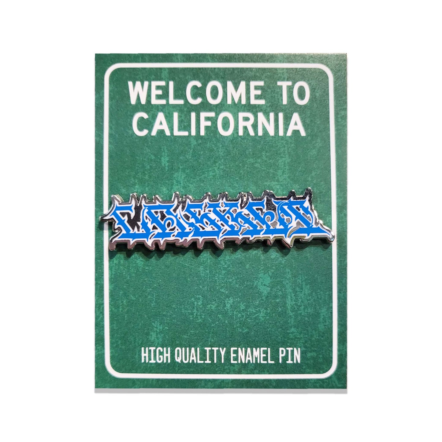 A blue and silver metal enamel pin with graffiti stylized gothic lettering reading 'CASKET' on a green backer card.