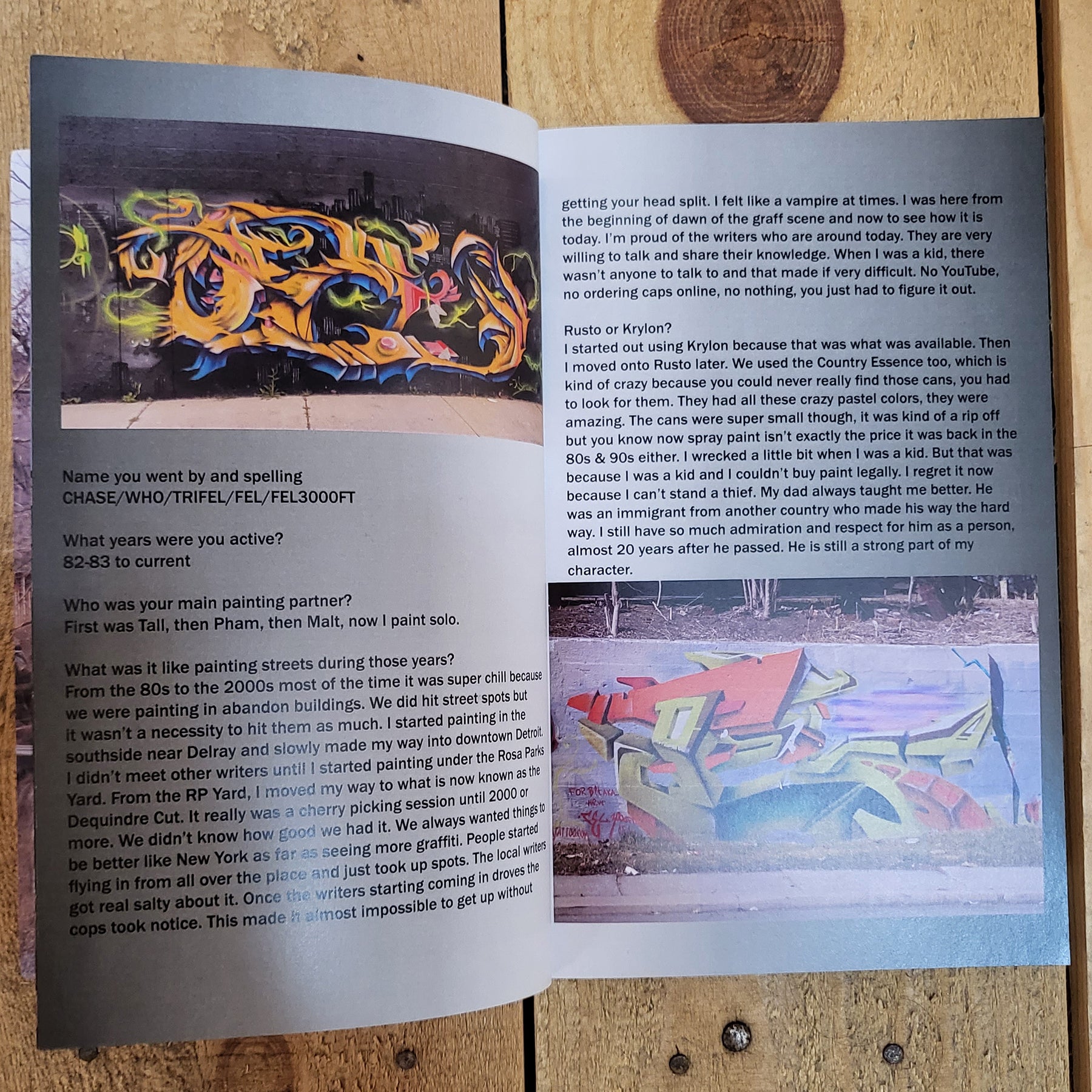 An open magazine, the left page shows a photo of a graffiti piece with an interview written underneath. The right page shows a photo of graffiti at the bottom with the continued interview at the top.