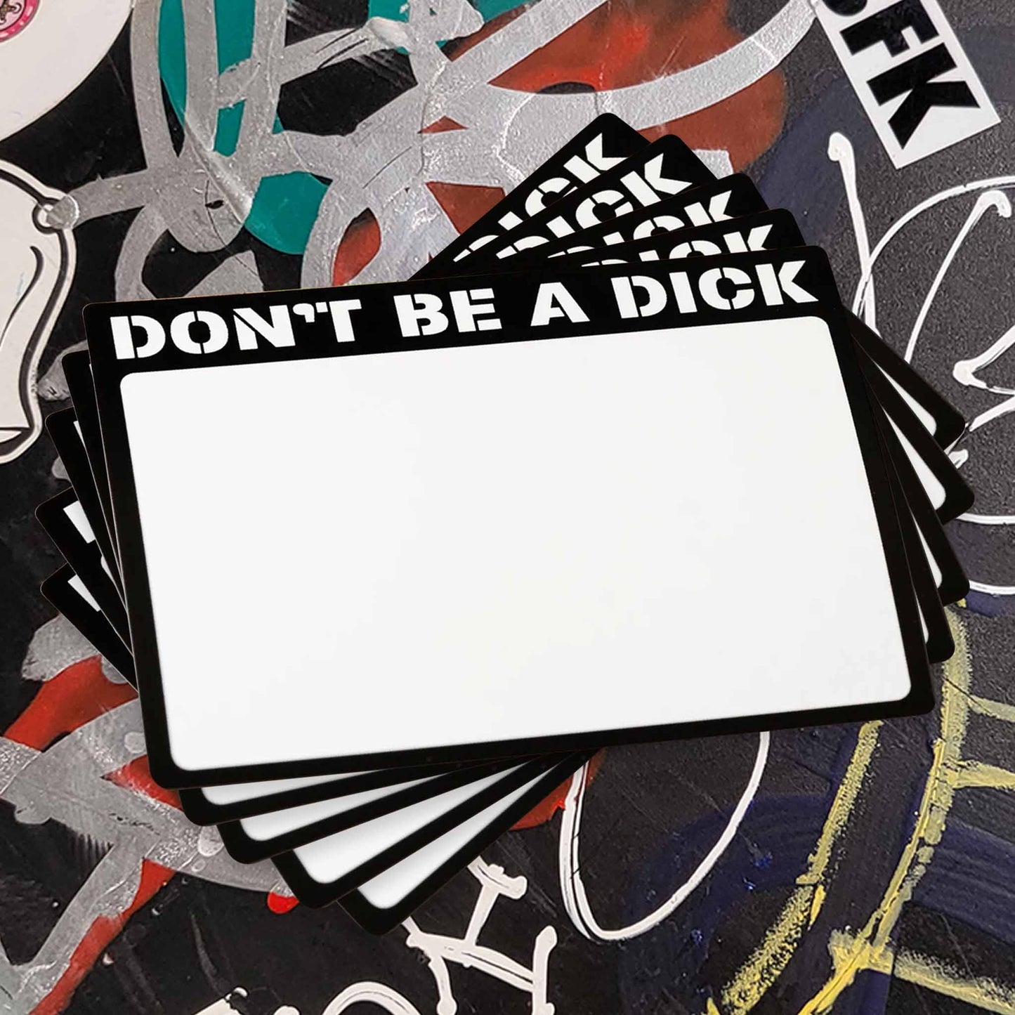 20 stack of white stickers with a black boarder reading "Don't Be A Dick".