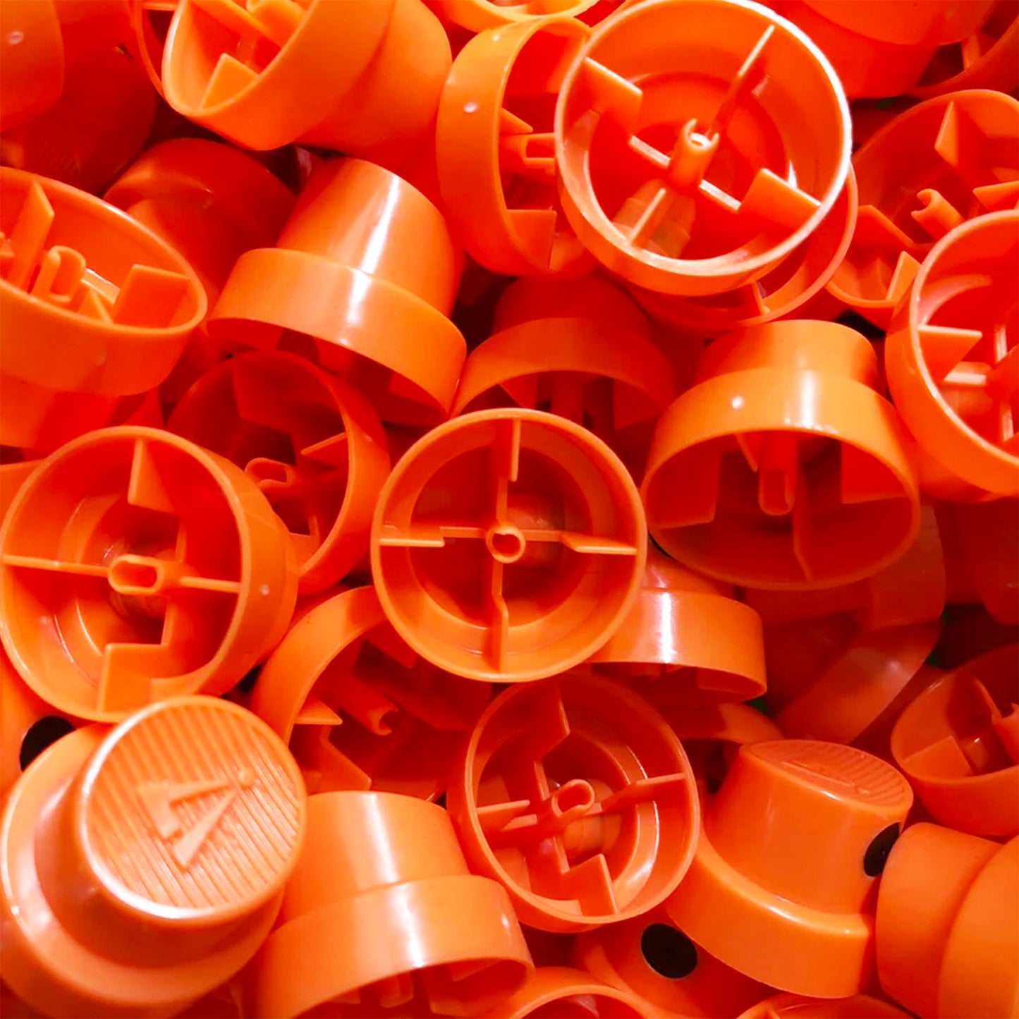 a pile of Hardcore fat spray paint nozzles.