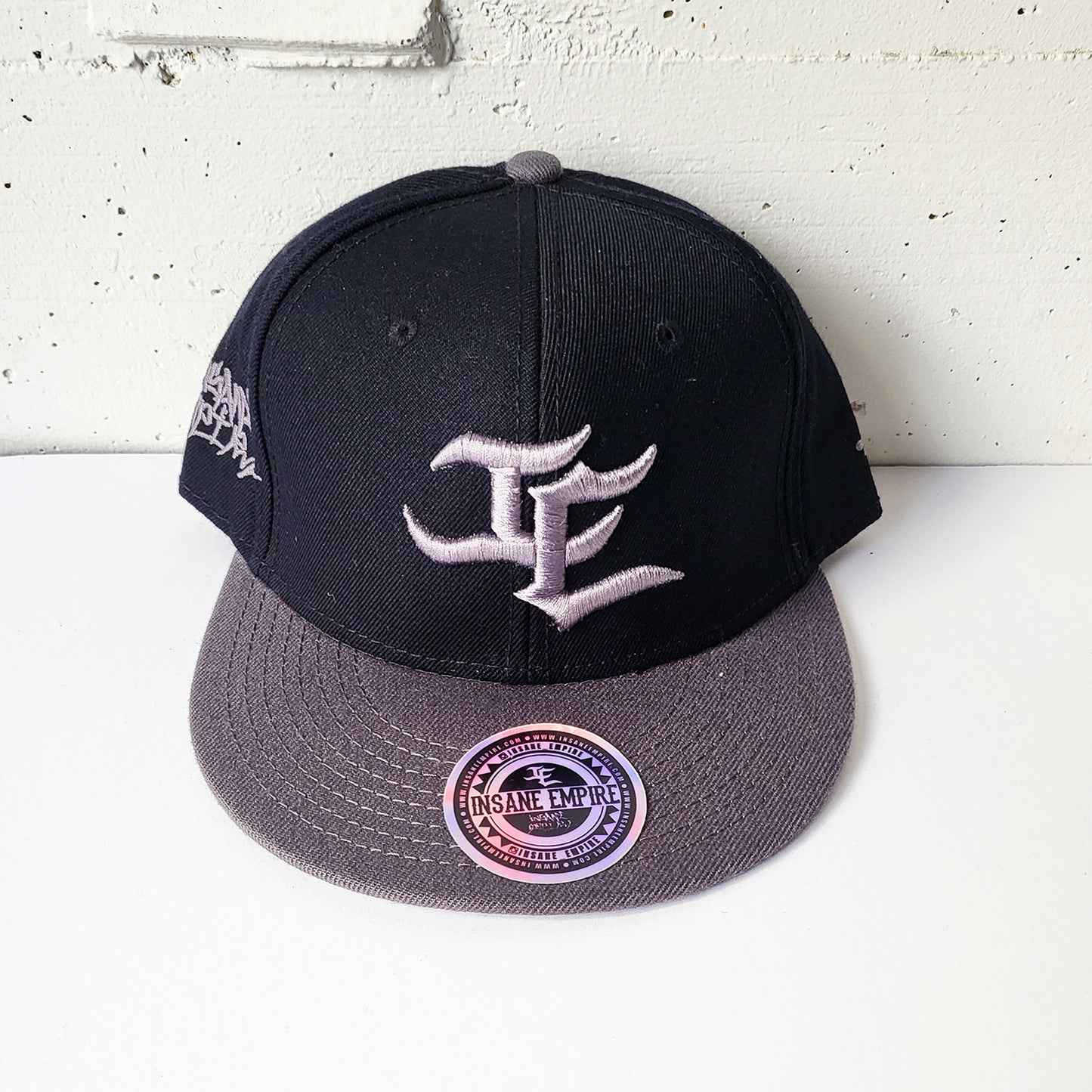 Local graffiti artist clothing brand inland empire grey on black and grey snap back hat