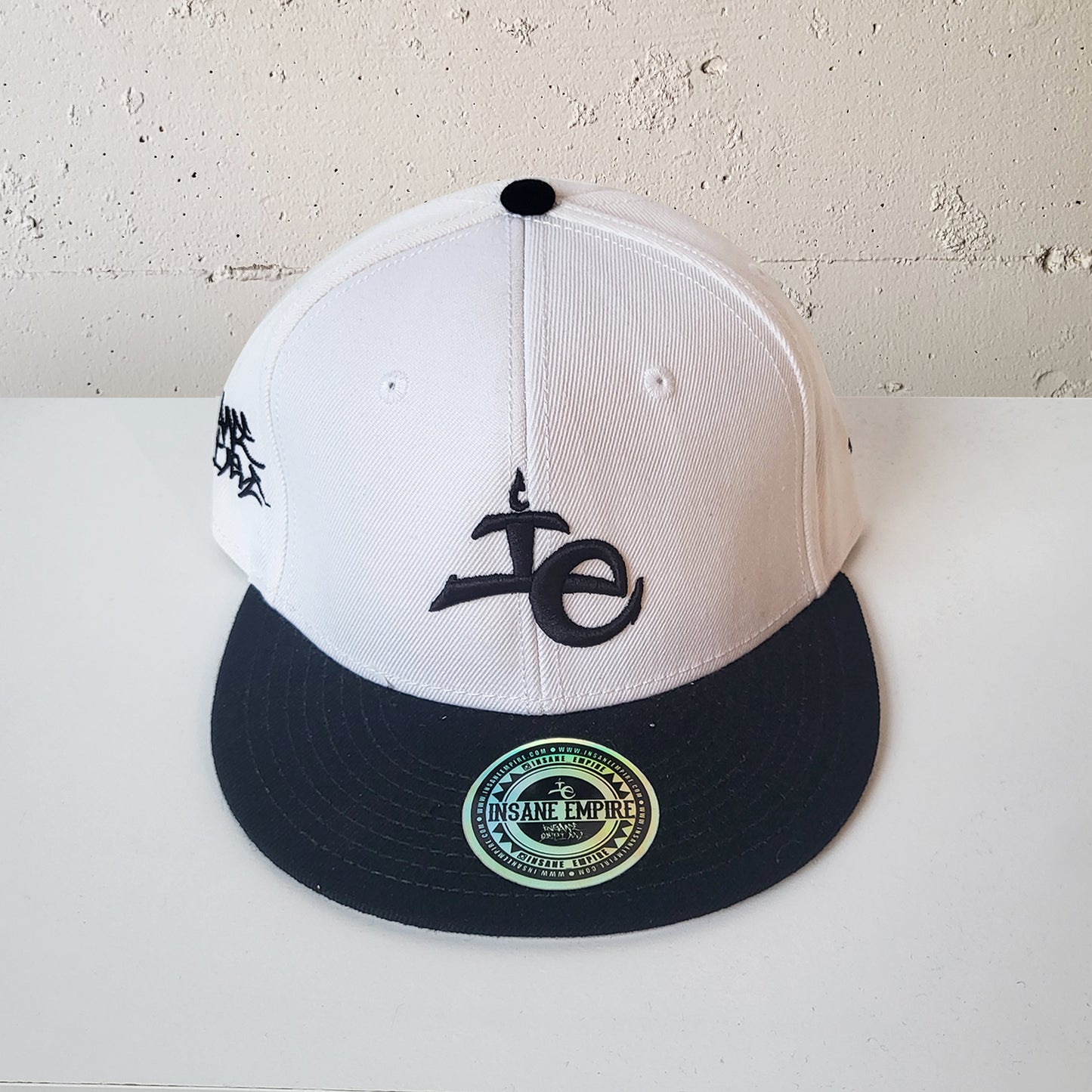 Local artist clothing brand inland empire white and black snap back lowercase