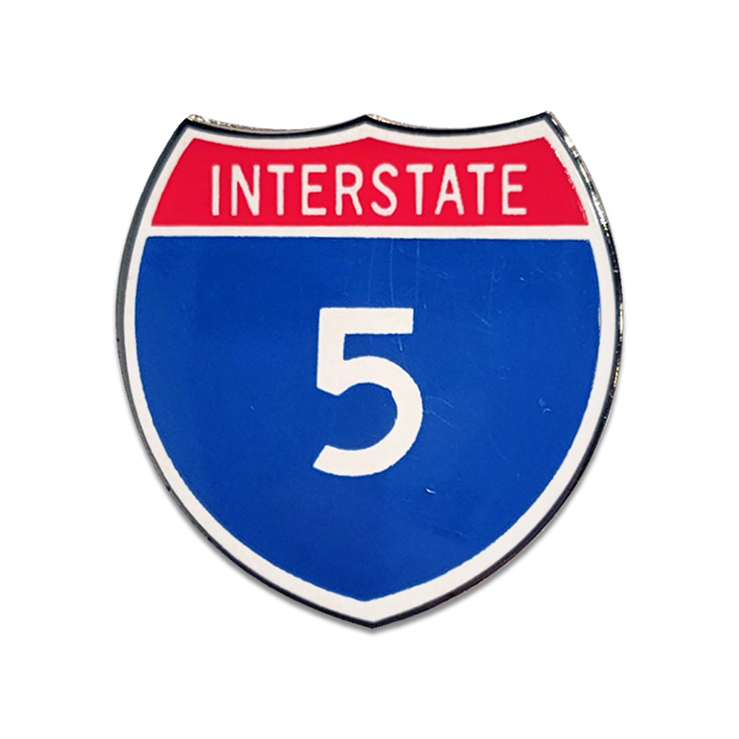 Shiny enamel pin shaped like an interstate highway shield with 'INTERSTATE 5' on a white background.