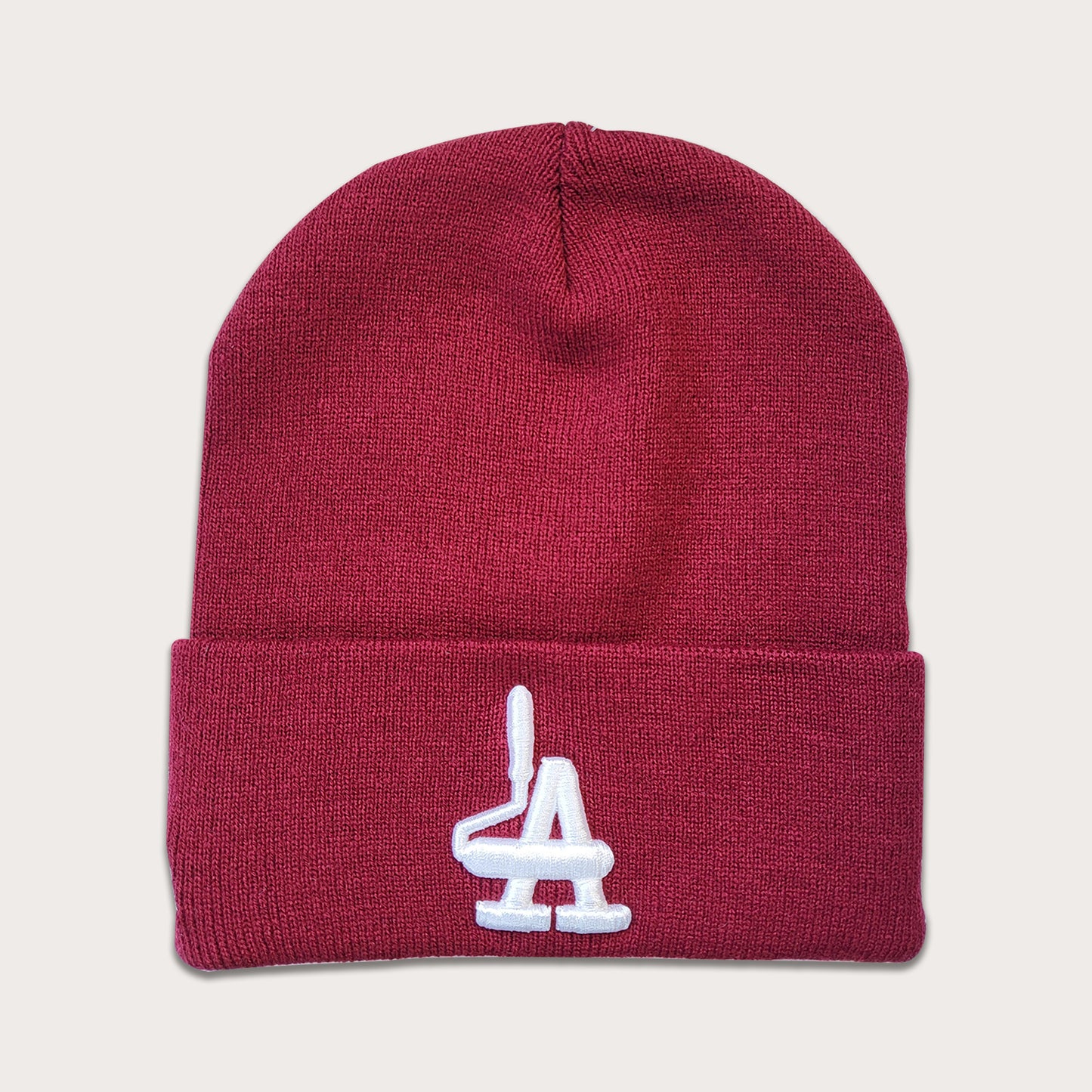 Locally owned graffiti brand Phatcaps, woven light burgundy beanies with white puff embroidery.
