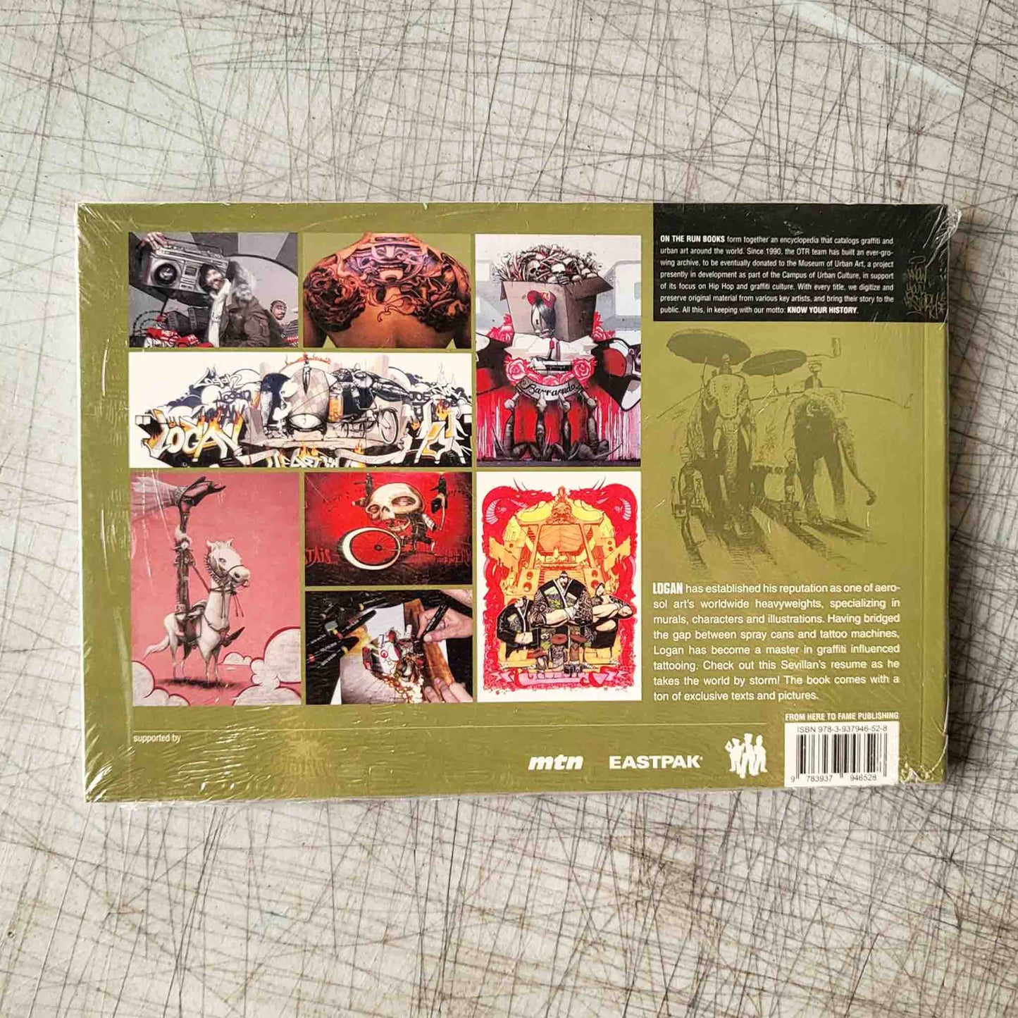 Book "Logan" back cover with colorful graffiti graphics on a textured surface