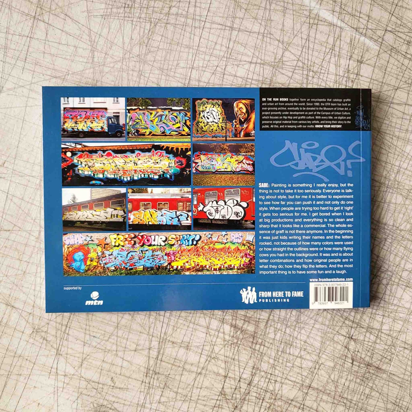 Back cover of a book with colorful graffiti images on a textured surface
