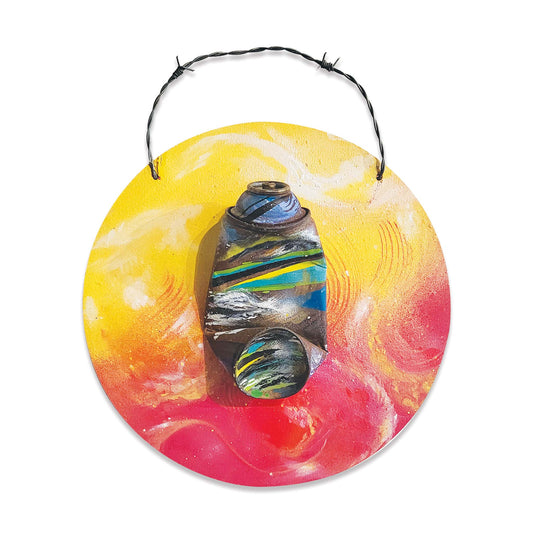 Brightly painted wall hanging art with crushed spray paint an and barbed wire hook.