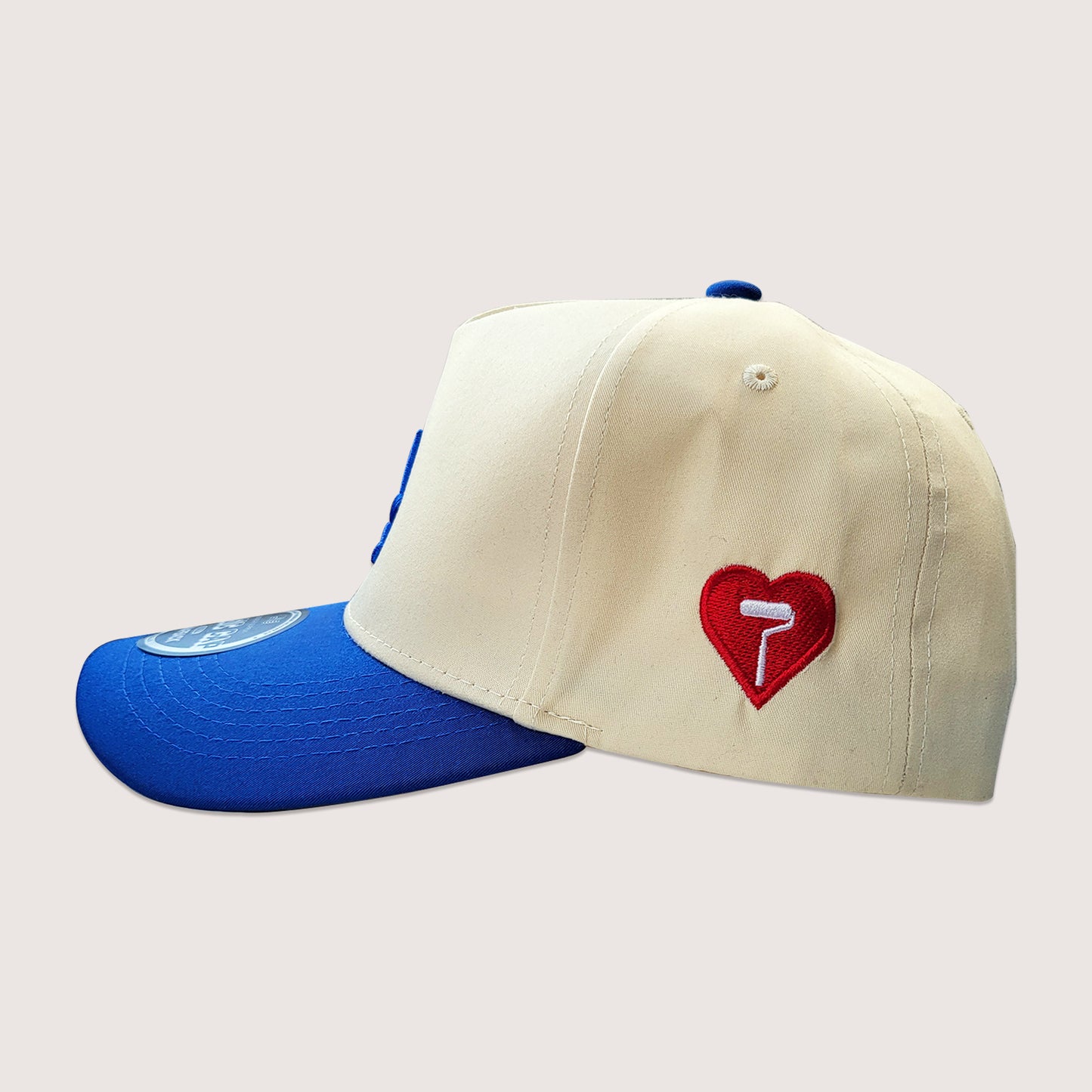 Phatcaps brand cream baseball cap with dodger blue embroidery side profile. 