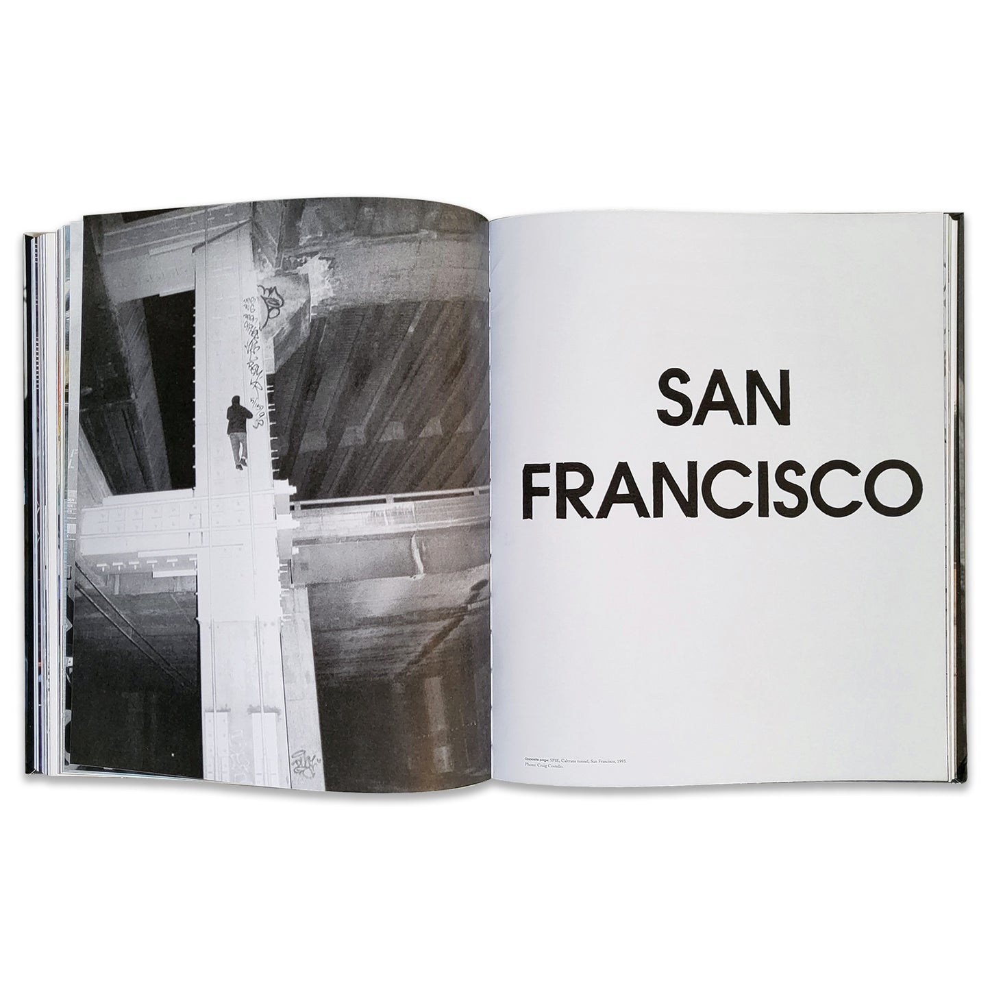 An open book with the chapter title 'San Fransisco' with a photo of a person scaling a bridge.