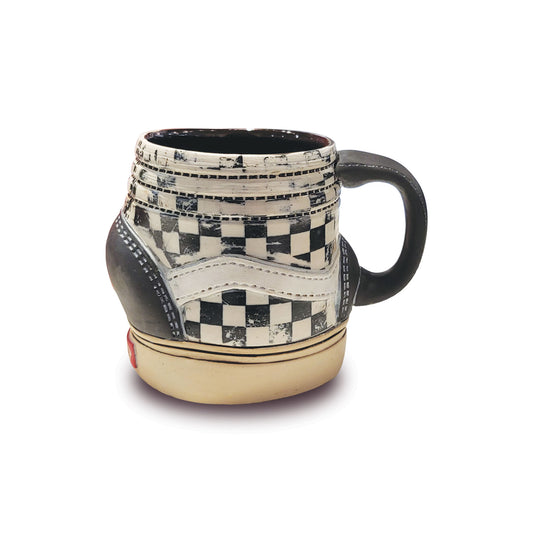 Checkered Vans Sneaker mug with a black handle on a white background.