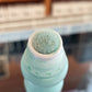 A close up photo of a textured felt marker nib, marker color is aqua with a blurred background.