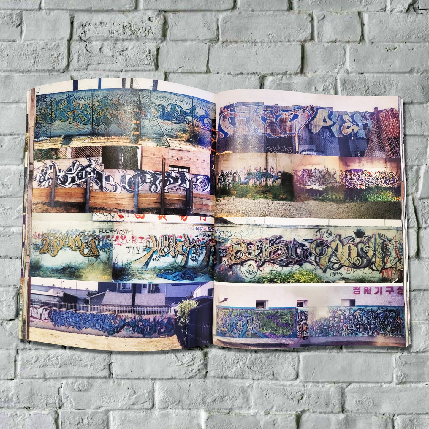 An open magazine with pictures of graffiti on walls.