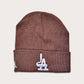 Locally owned graffiti brand Phatcaps, woven medium brown beanies with white puff embroidery.