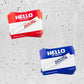 Red and Blue "hello my name is" Montana can sticker packs with marker to match on a concrete background