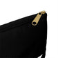 The corner of a black, fabric, pencil bag, zoomed in on the gold zipperer