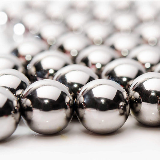 Close up photo of metal beads in rows that fade out of focus towards the back