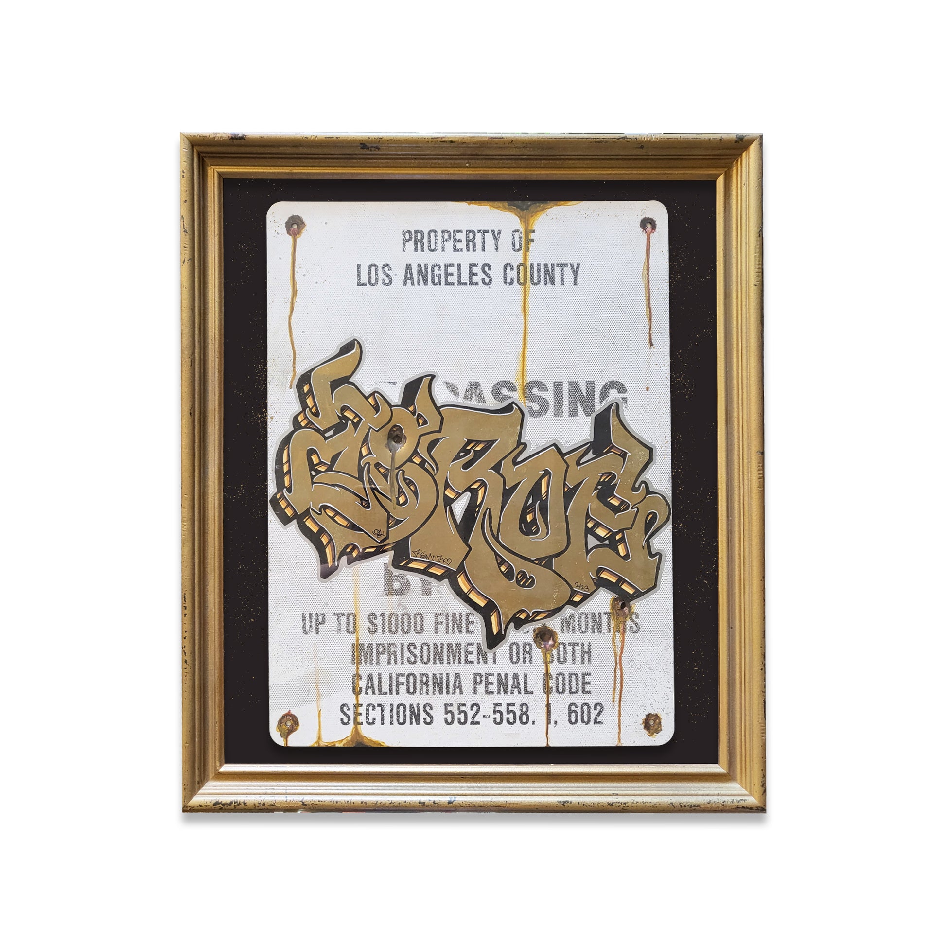 Gold framed metal sign with grafiti writing in gold