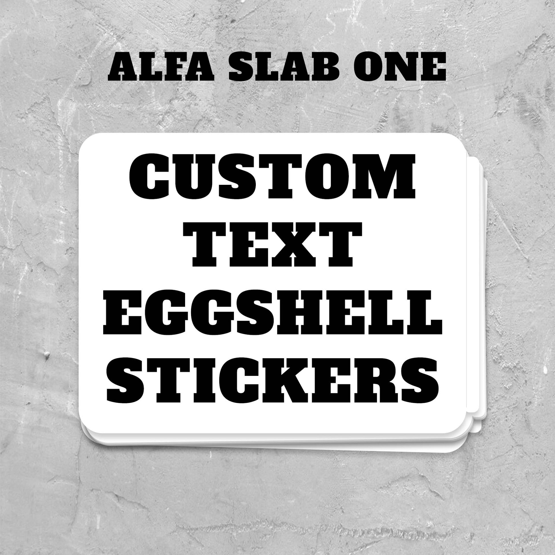 Stack of custom text eggsell stickers with 'Alfa Slab One' text on a gray textured background.