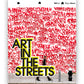 A white book with Art In The Streets written with red spray paint tags.