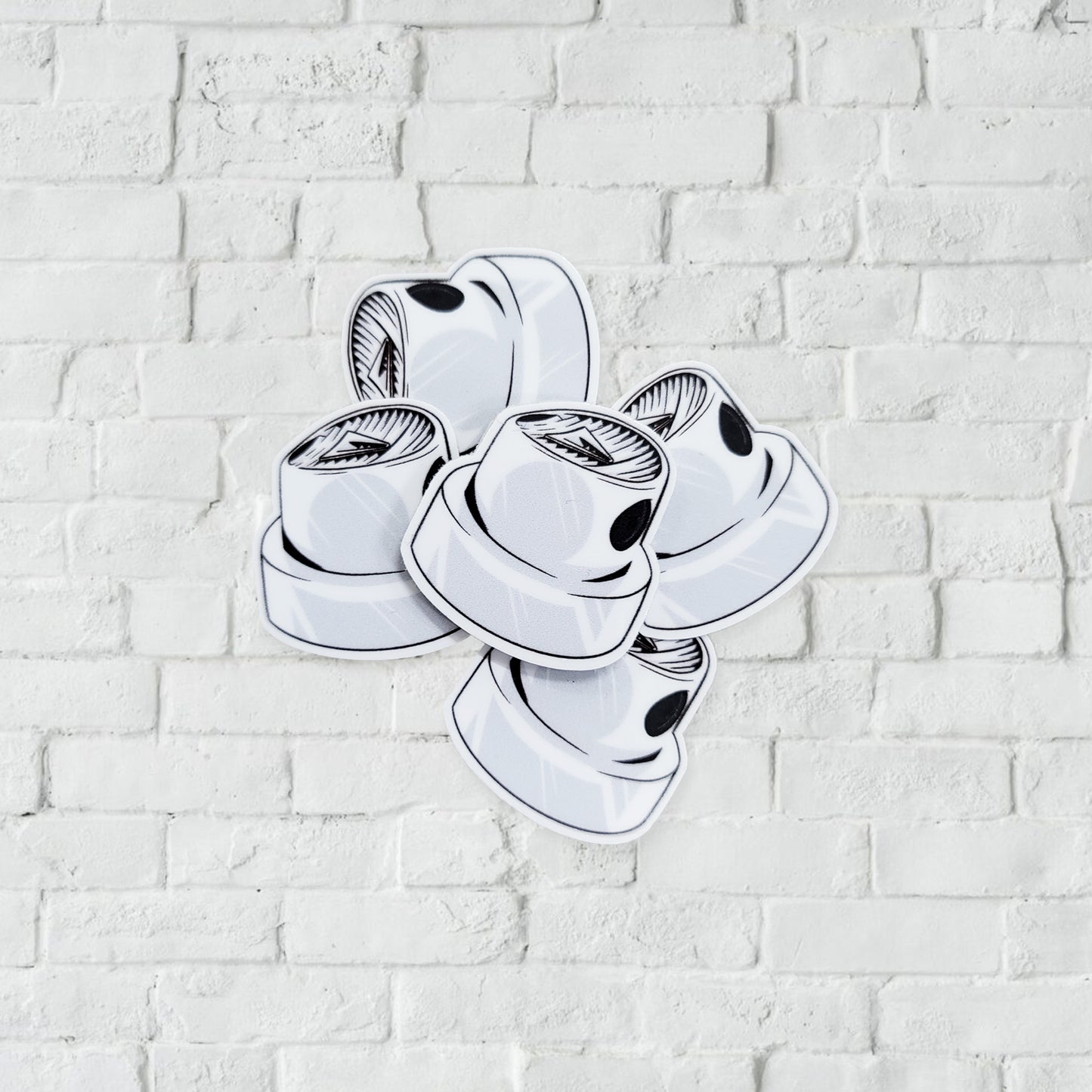 White and black stickers with illustration of a spray paint nozzle.