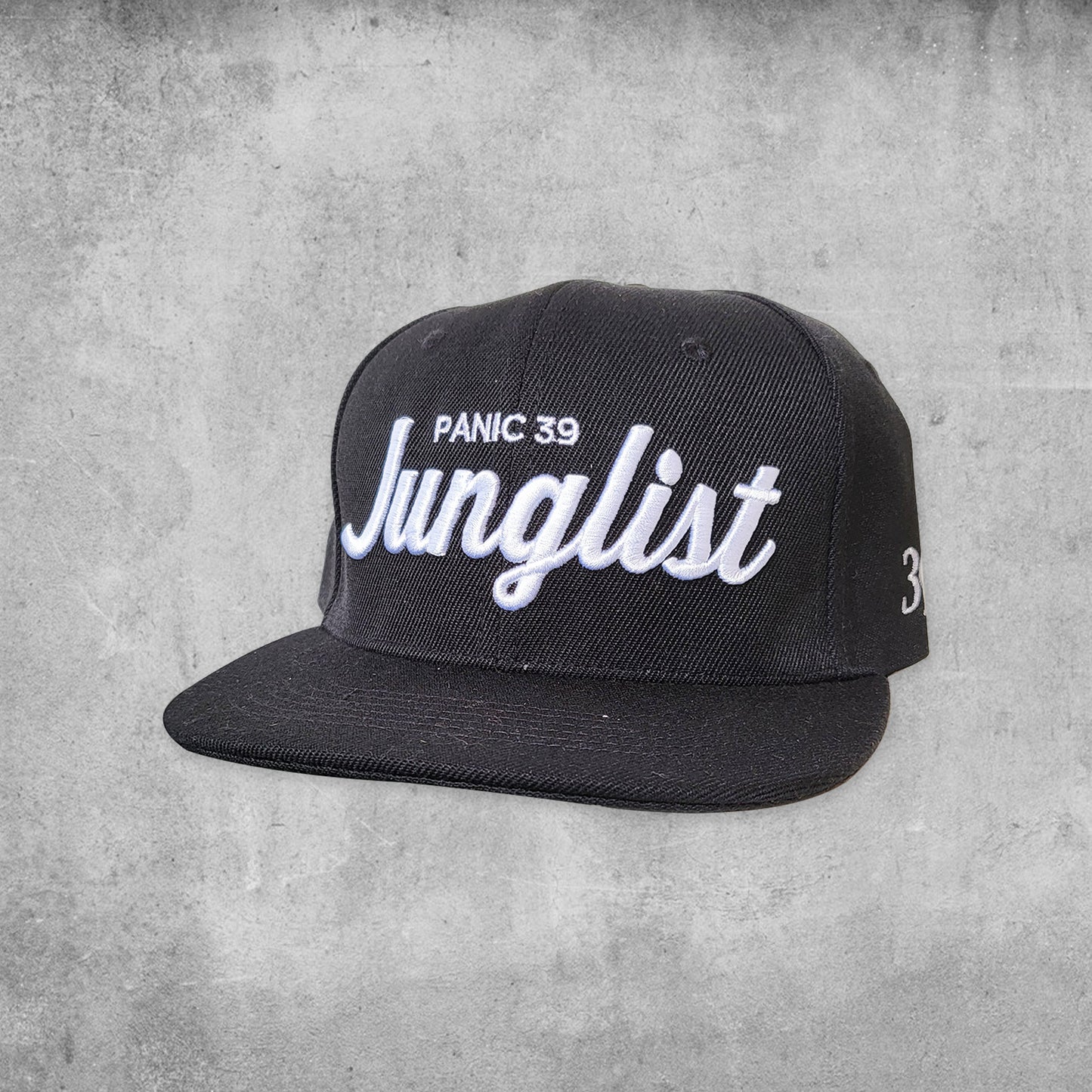 Panic 39 branded snap back hat in black with white puff embroidery.