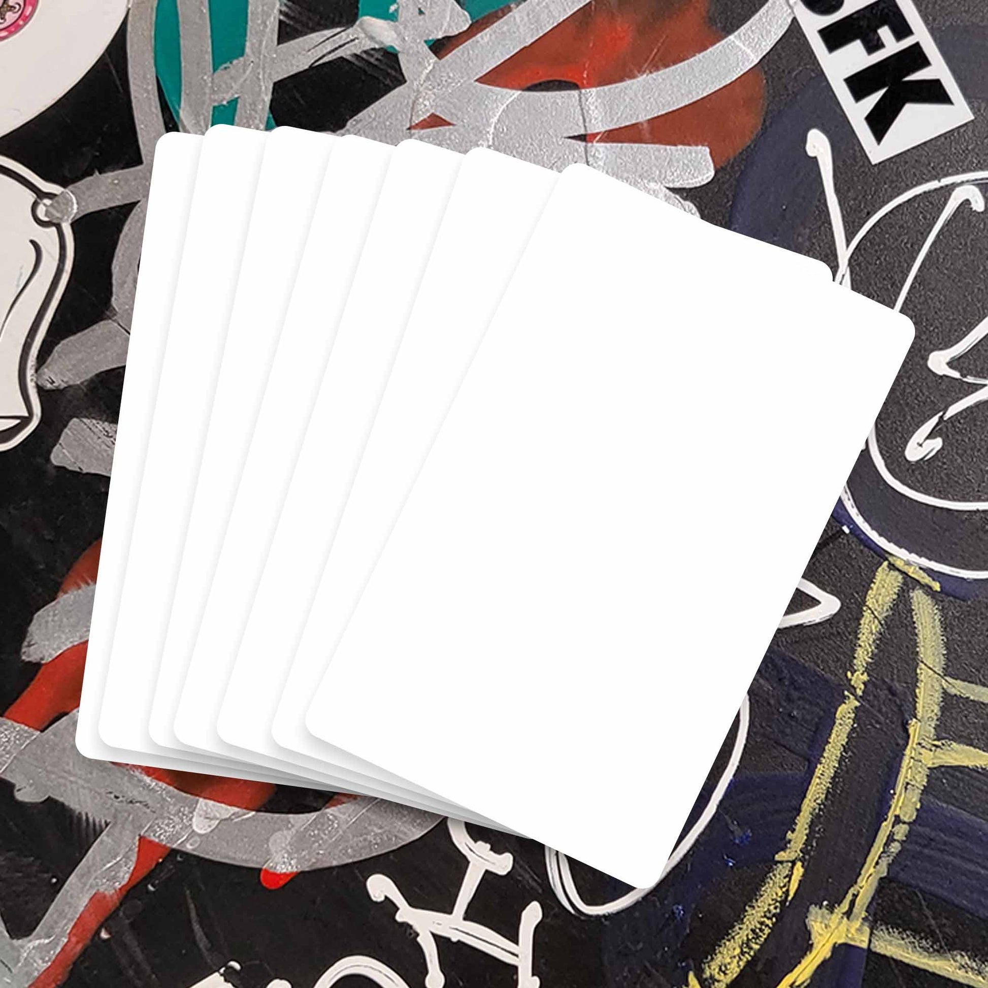 Multiple blank white sticker pack on black background with colorful writing.