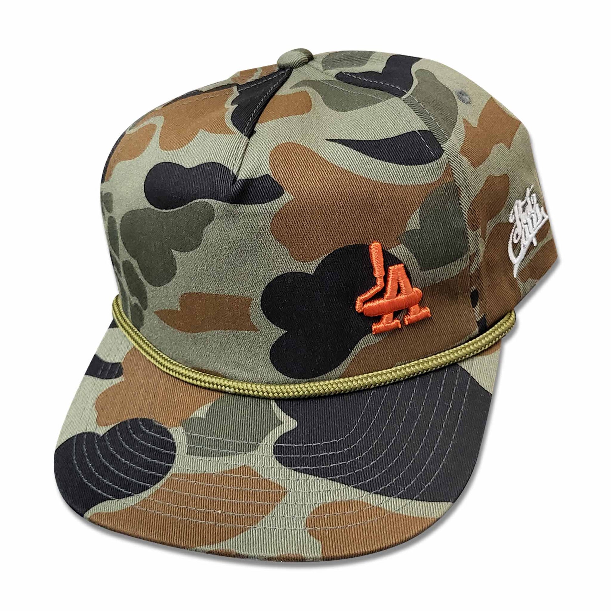 Camo hat with orange embroidery of paint rollers in the shape of the acronym LA.