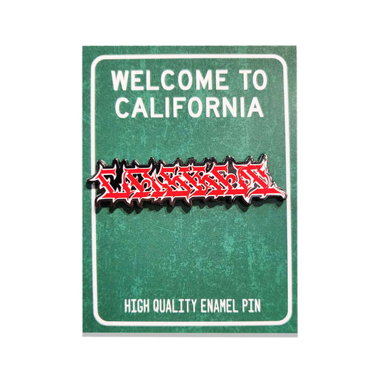 A red and black metal enamel pin with graffiti stylized gothic lettering reading 'CASKET' on a green backer card.