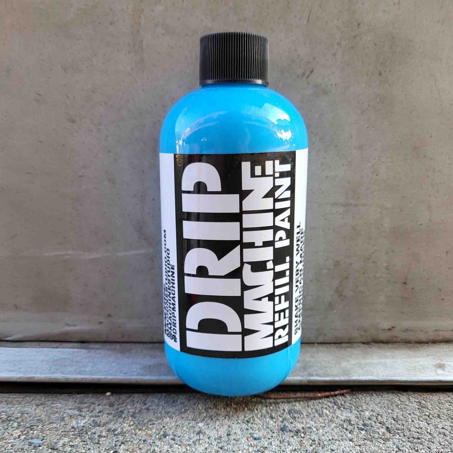 Blue bottle of Drip Machine Refill Paint in blue.