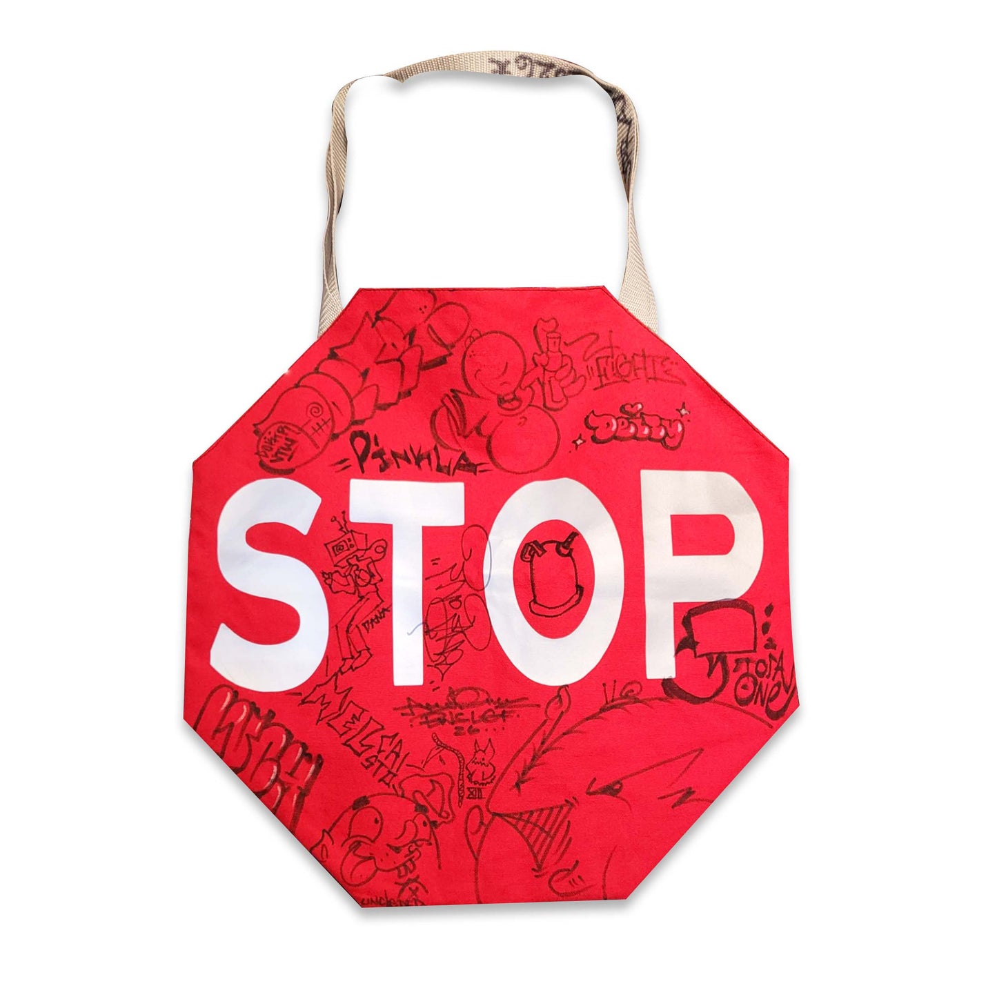 Red stop sign tote bag with shoulder strap and graffiti style drawings.