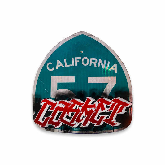 Decorative sign with 'California 57' text and painted in red CASKET on a white background.