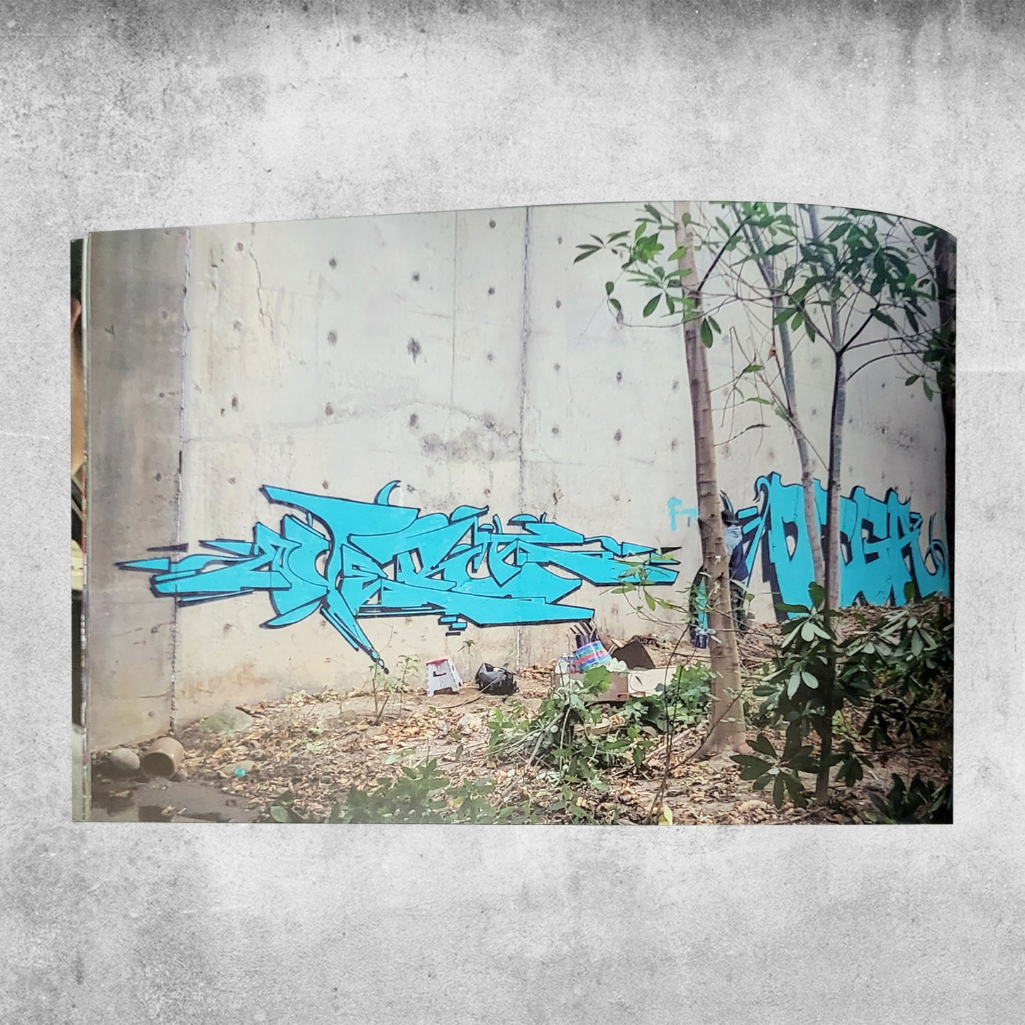 Self published graffiti magazine/zine with graff photography taken by artist overt, photo of graffiti on concrete wall.