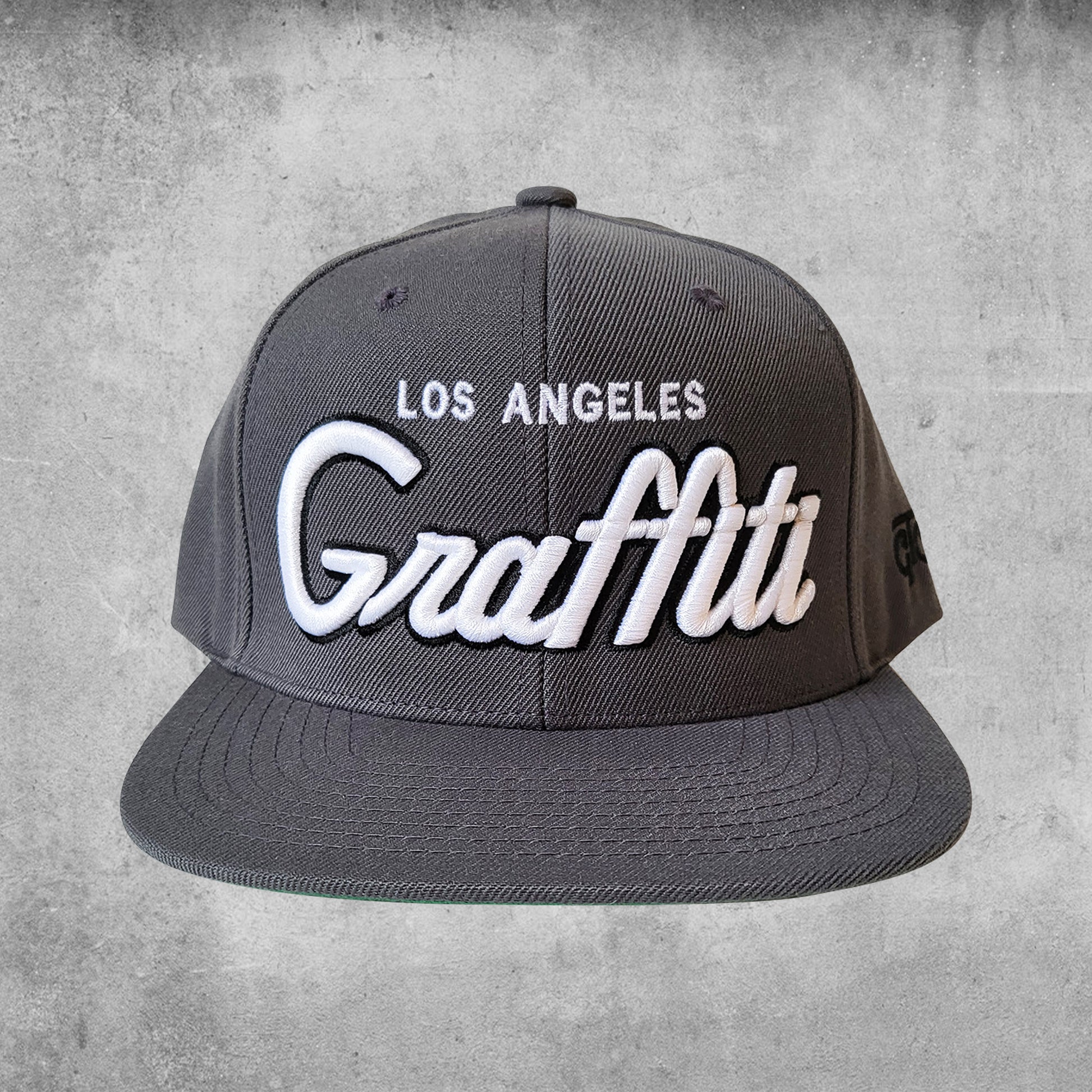 Graffiti the city Los Angeles snap back hat in grey and white.
