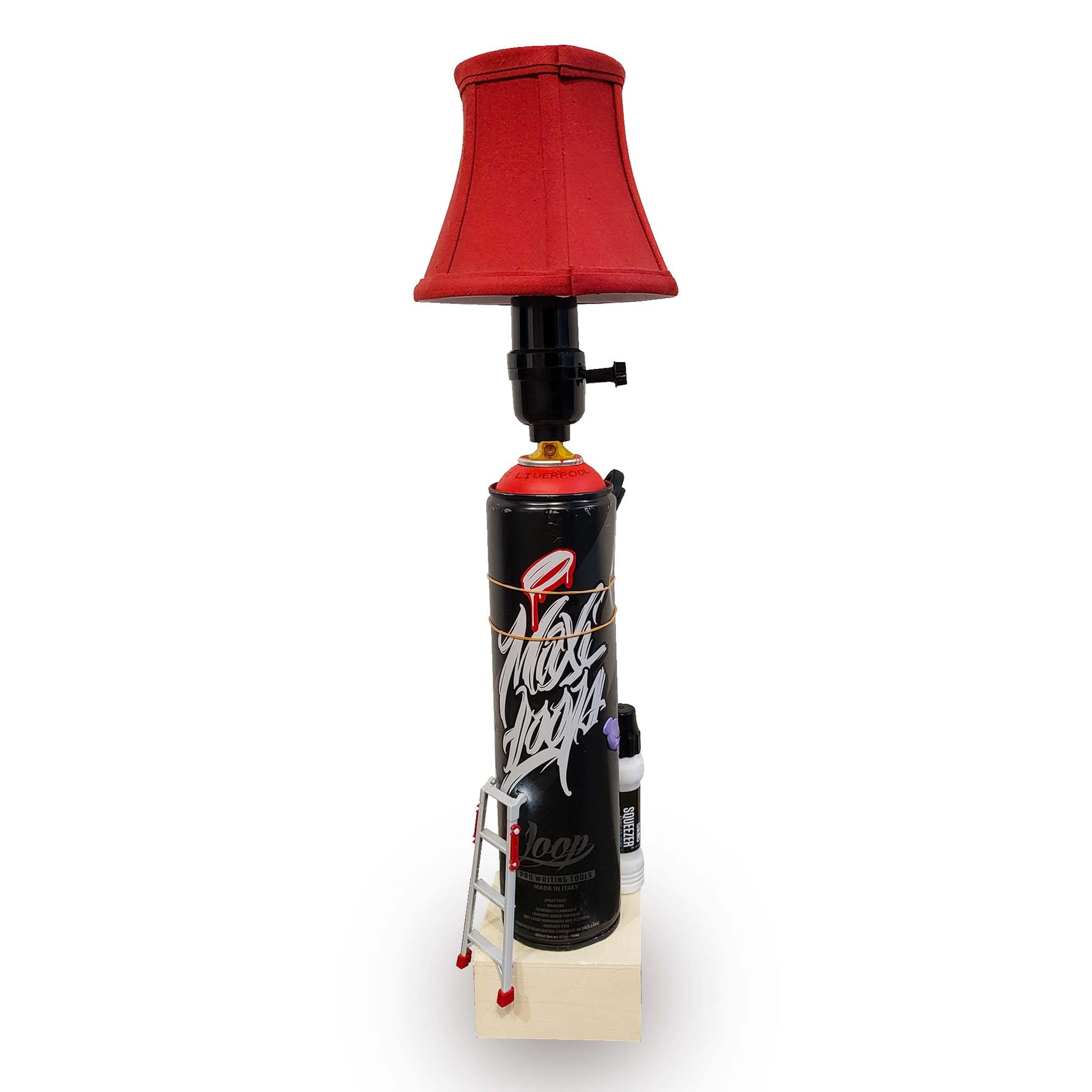 Lamp made from a Loop Maxi spray paint can with a red lampshade on a white background.