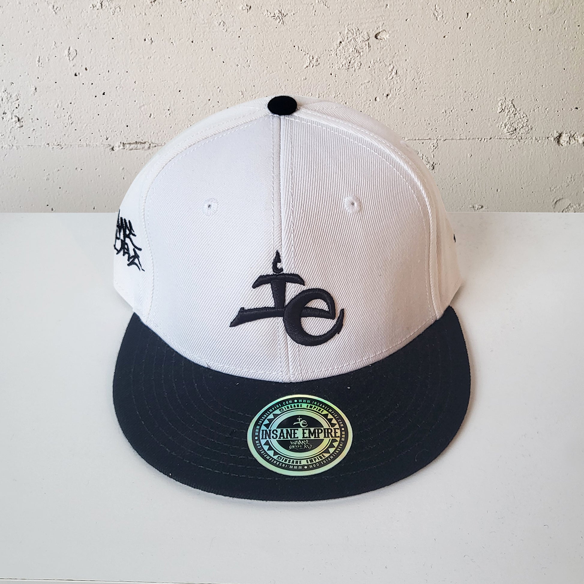 Local artist clothing brand inland empire white and black snap back lowercase