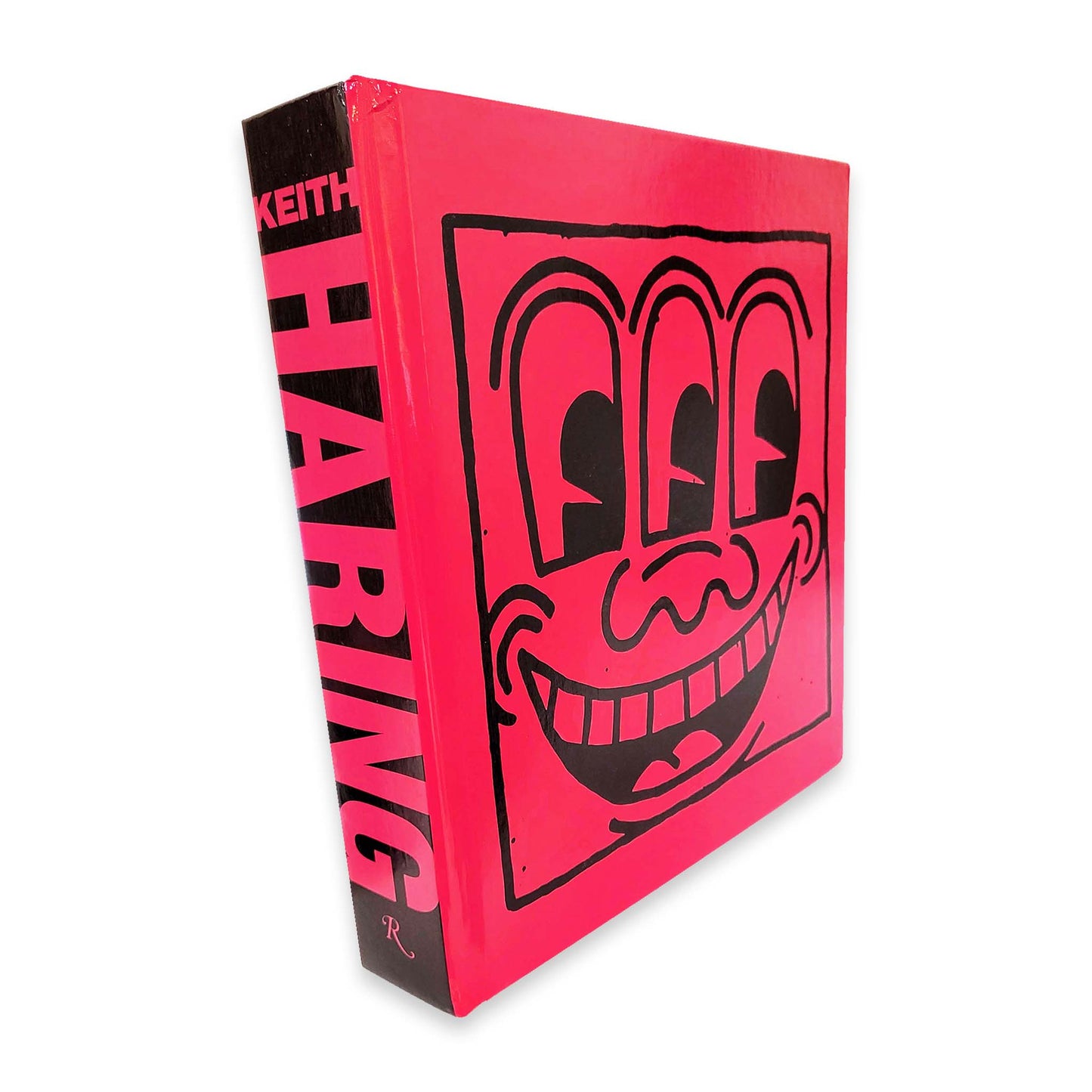 Book with a stylized face design on a red background, featuring the name 'Keith Haring'.