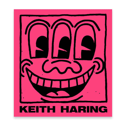 Keith Haring artwork with a black smiley face on a pink book cover.