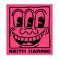 Keith Haring artwork with a black smiley face on a pink book cover.