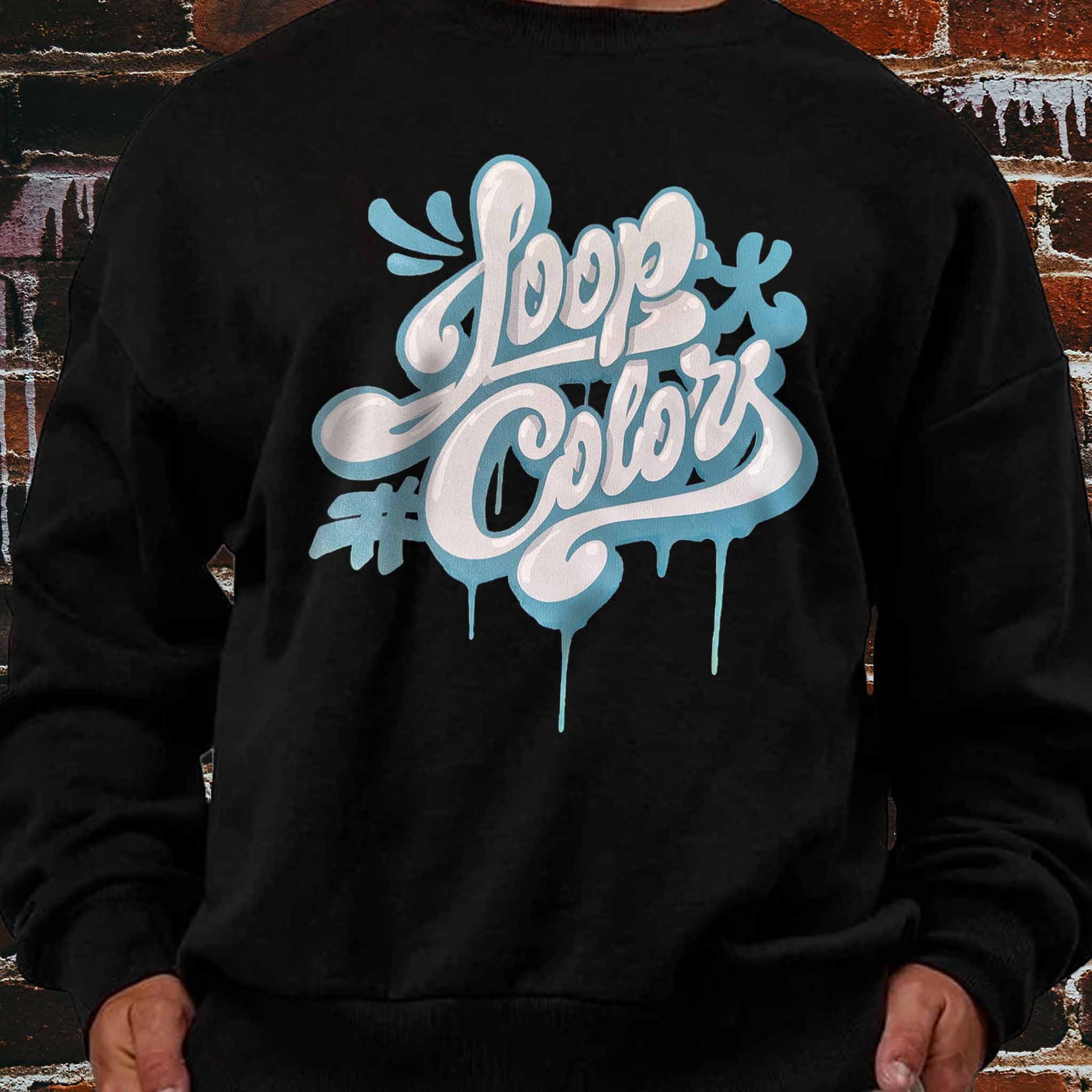 Black sweatshirt with 'Loop Colors' throwie style graphic design on a brick wall background
