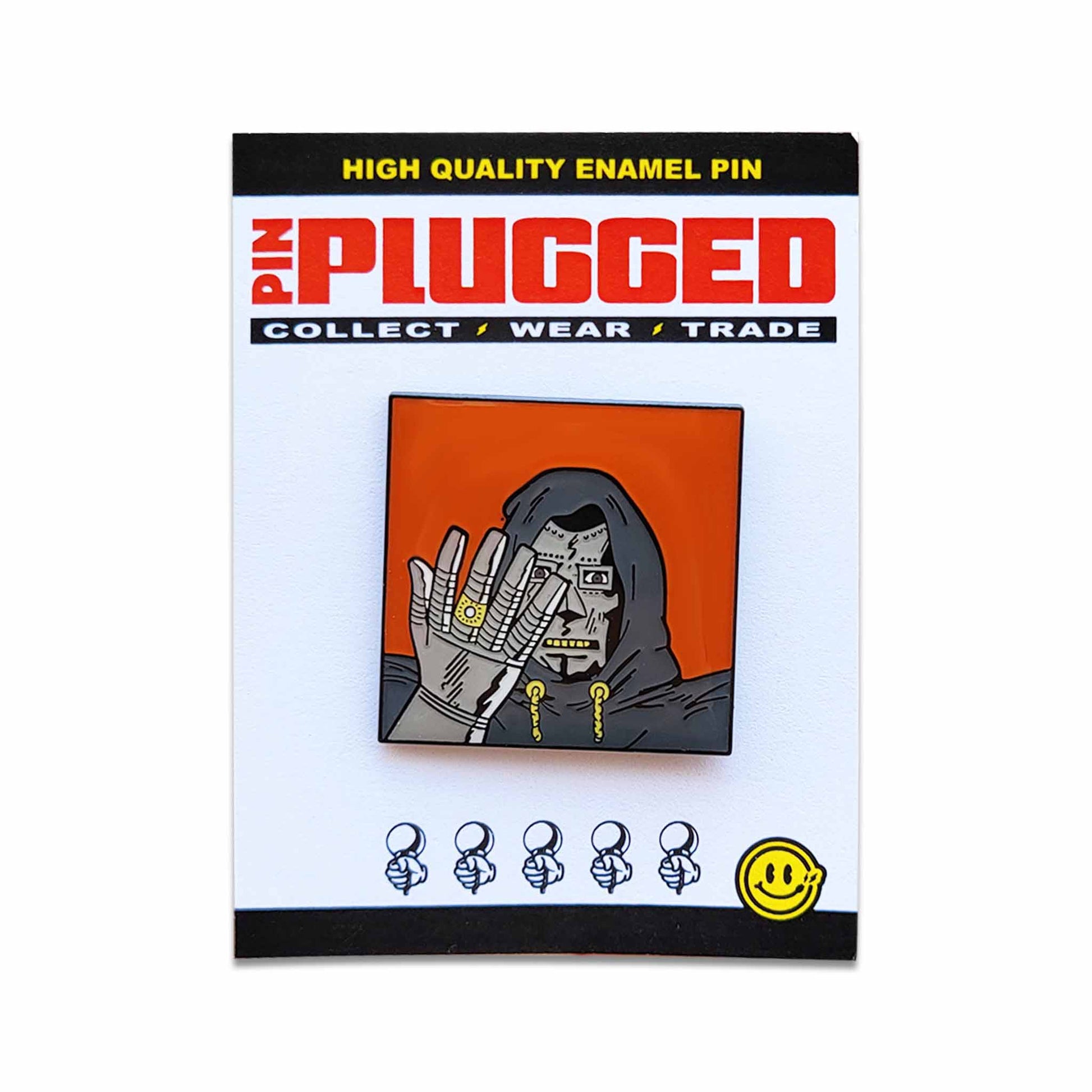 Carded orange and grey hooded character with metal mask and glove pin