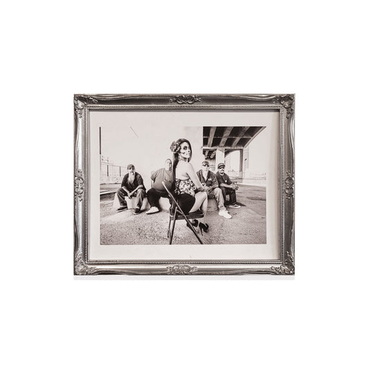 Silver frame with a black and white photo of a woman with a sugar skull painted face.