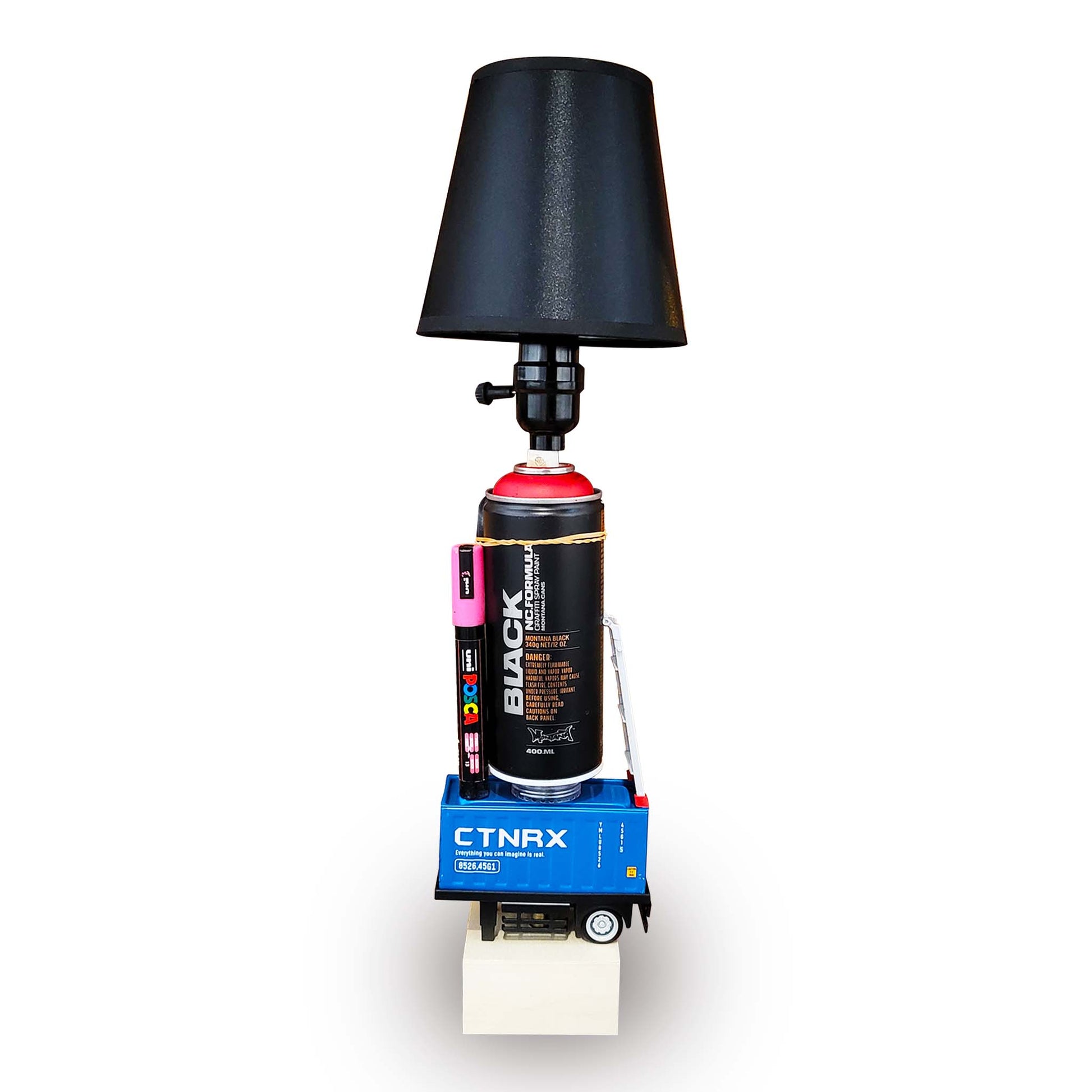 Black spray can with a black lamp shade on a white background.