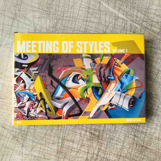Book titled 'Meeting of Styles Volume 1' with colorful abstract design on a textured surface