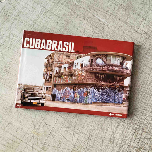 Book titled 'CUBABRASIL' with a cover featuring a vintage car and graffitied building on a textured surface