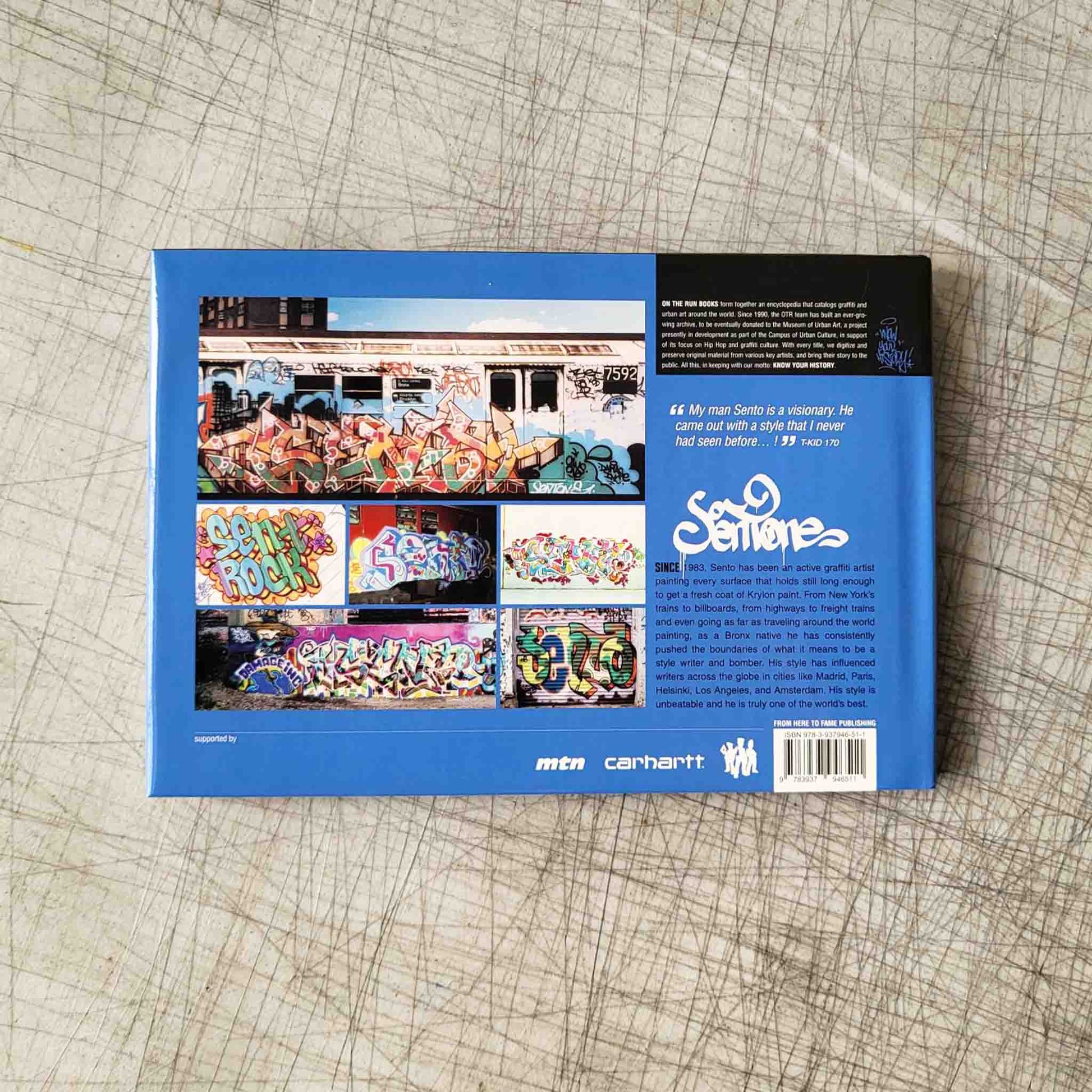 Blue book cover with colorful graffiti graphics and text on a textured surface