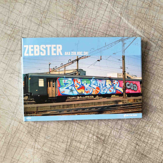 Book titled 'Zebster' with a cover featuring a graffiti-covered train on a textured surface