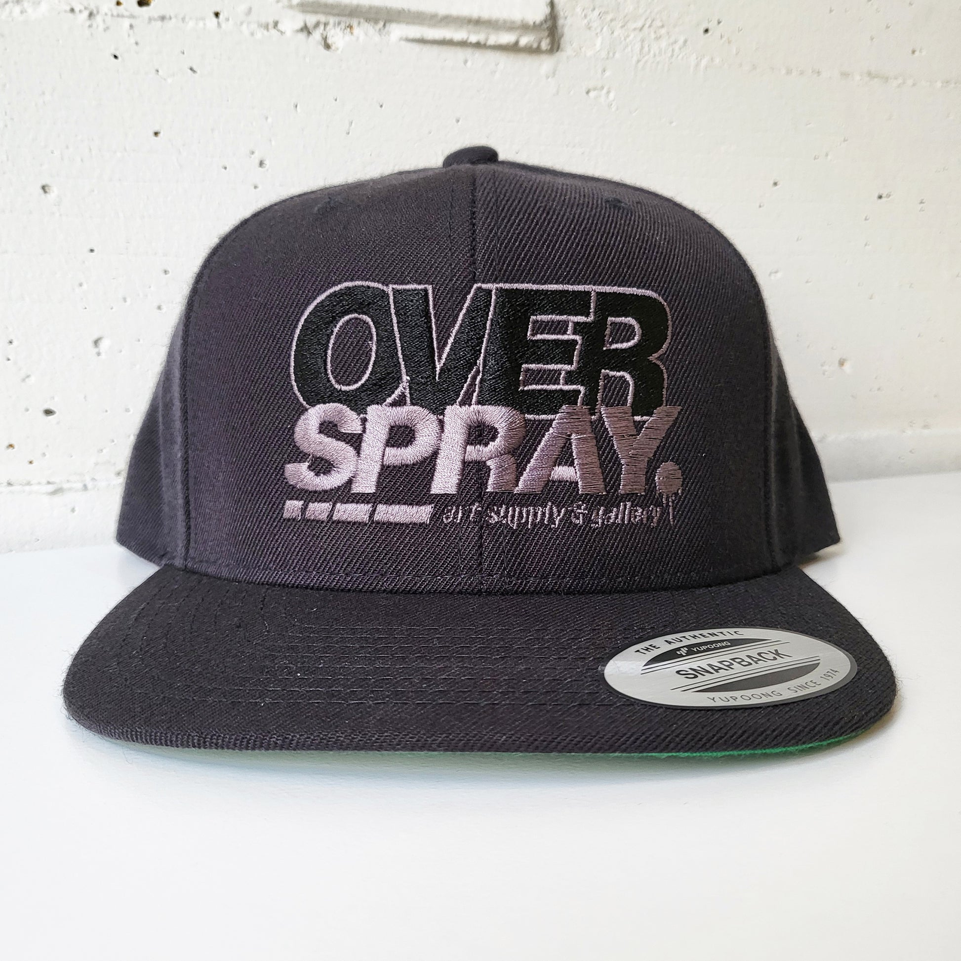 Overspray graffiti shop branded snap back hat in grey.