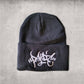 Black beanie hat with white centered  front embroidery reading Panic in tag font
